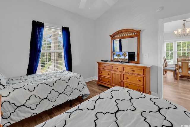 4811 Orchid Way Unit 301, Myrtle Beach, SC 29577 - bedroom featuring a chandelier, light wood-style flooring, and vaulted ceiling