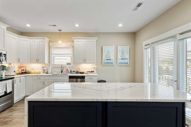 141 Marblehead Dr, Little River, SC 29566 - kitchen with appliances with stainless steel finishes, a sink, plenty of natural light, a center island, and recessed lighting