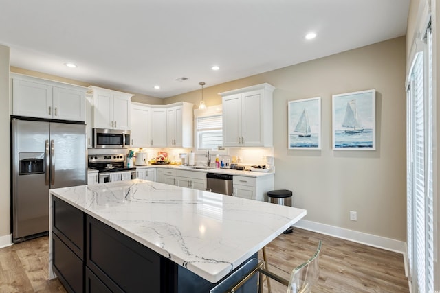 141 Marblehead Dr, Little River, SC 29566 - kitchen with stainless steel appliances, a sink, baseboards, white cabinets, and recessed lighting