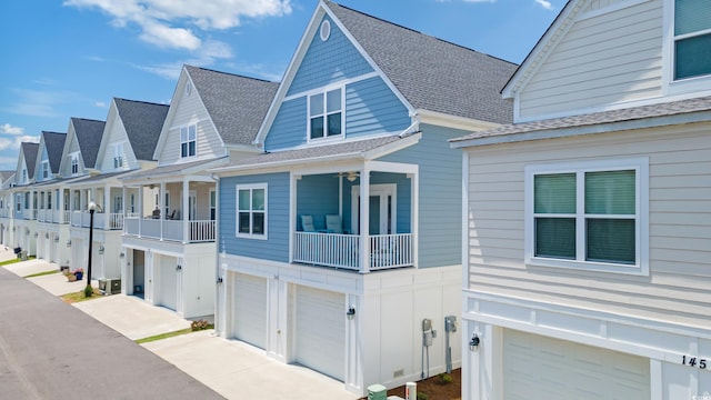 141 Marblehead Dr, Little River, SC 29566 - view of front of home with an attached garage, a shingled roof, a balcony, concrete driveway, and board and batten siding