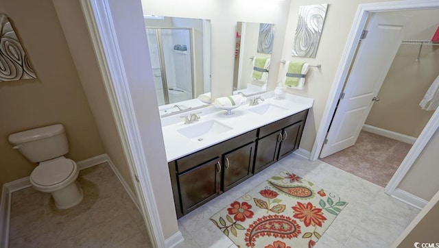 744 Choctaw Dr, Conway, SC 29526 - bathroom featuring double vanity, a shower stall, a spacious closet, toilet, and baseboards