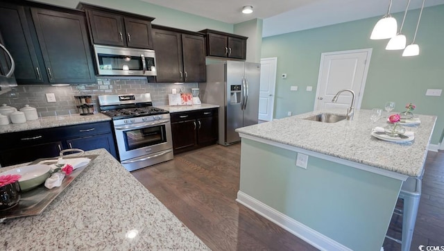 744 Choctaw Dr, Conway, SC 29526 - kitchen with stainless steel appliances, a sink, dark wood finished floors, backsplash, and decorative light fixtures