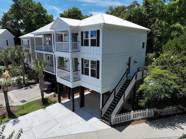 52 Fish Shack Aly, Murrells Inlet, SC 29576 - back of house featuring a carport, a balcony, stairs, driveway, and a metal roof