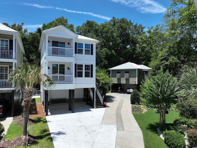 52 Fish Shack Aly, Murrells Inlet, SC 29576 - coastal home with a carport, concrete driveway, a balcony, and board and batten siding