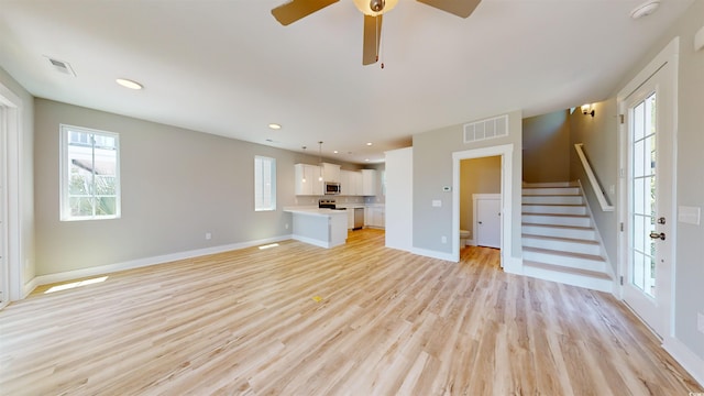 52 Fish Shack Aly, Murrells Inlet, SC 29576 - unfurnished living room with stairway, plenty of natural light, light wood-style flooring, and recessed lighting