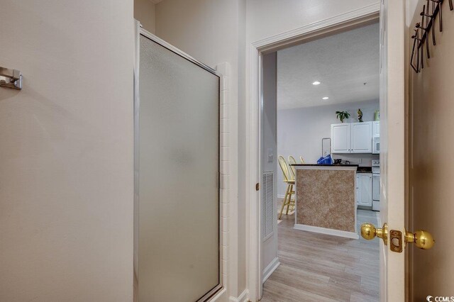 601 Hillside Dr N Unit 3704, North Myrtle Beach, SC 29582 - bathroom with a stall shower, wood finished floors, baseboards, and recessed lighting