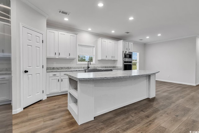 1529 Bucksport Rd, Conway, SC 29527 - kitchen with stainless steel appliances, crown molding, a sink, a center island, and open shelves