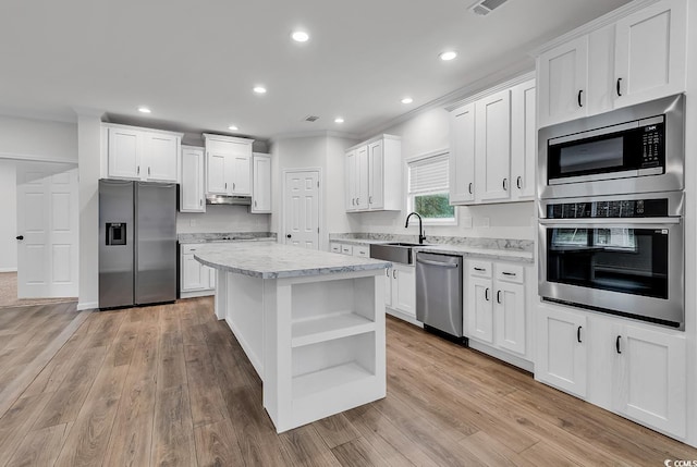 1529 Bucksport Rd, Conway, SC 29527 - kitchen featuring stainless steel appliances, open shelves, a sink, white cabinets, and a center island