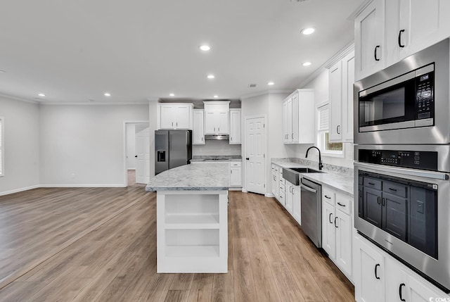 1529 Bucksport Rd, Conway, SC 29527 - kitchen featuring appliances with stainless steel finishes, a sink, open shelves, crown molding, and a center island