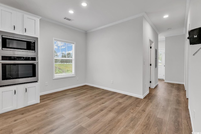 1529 Bucksport Rd, Conway, SC 29527 - kitchen with stainless steel appliances, ornamental molding, light wood-style floors, white cabinetry, and baseboards