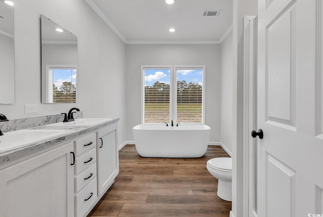 1529 Bucksport Rd, Conway, SC 29527 - bathroom with crown molding, a soaking tub, double vanity, wood finished floors, and recessed lighting
