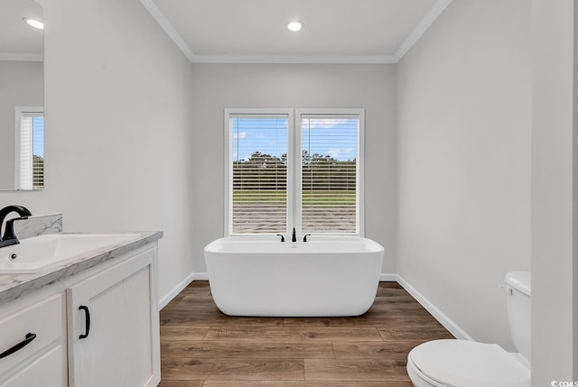 1529 Bucksport Rd, Conway, SC 29527 - bathroom with a freestanding tub, vanity, ornamental molding, toilet, and wood finished floors