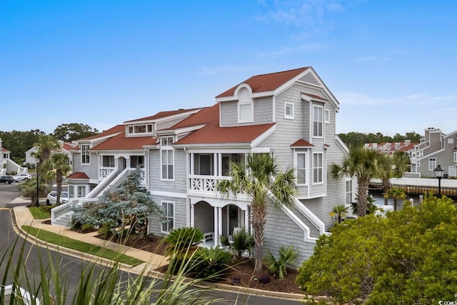 4396 Baldwin Ave Unit 30, Little River, SC 29566 - view of front facade with a residential view, a shingled roof, and a balcony