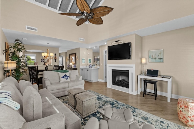 4396 Baldwin Ave Unit 30, Little River, SC 29566 - living room with a chandelier, wood finished floors, a ceiling fan, baseboards, and a high ceiling