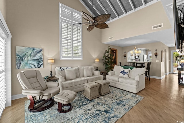 4396 Baldwin Ave Unit 30, Little River, SC 29566 - living area with arched walkways, high vaulted ceiling, a ceiling fan, light wood-style floors, and baseboards