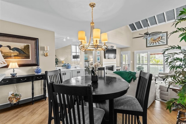4396 Baldwin Ave Unit 30, Little River, SC 29566 - dining area with a chandelier, light wood-style floors, lofted ceiling, a ceiling fan, and a fireplace