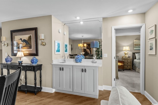 4396 Baldwin Ave Unit 30, Little River, SC 29566 - hall with a chandelier, baseboards, wood finished floors, recessed lighting, and a sink