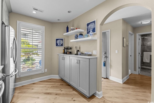 4396 Baldwin Ave Unit 30, Little River, SC 29566 - indoor dry bar featuring stainless steel fridge with ice dispenser, arched walkways, baseboards, light wood finished floors, and recessed lighting