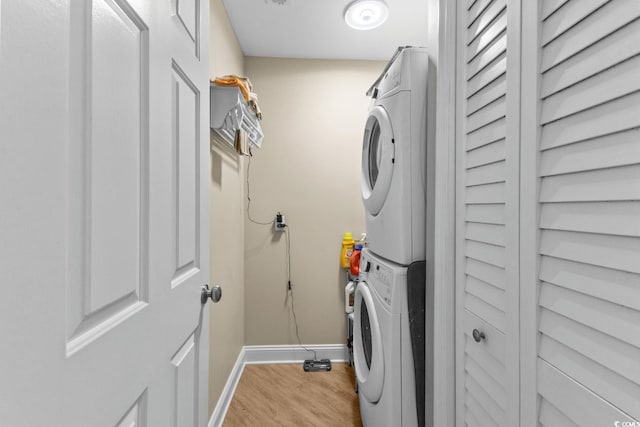 4396 Baldwin Ave Unit 30, Little River, SC 29566 - laundry room with stacked washing machine and dryer, light wood-style floors, and baseboards