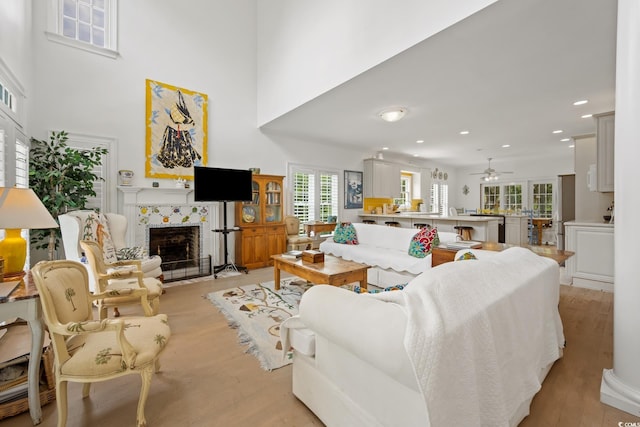 214 Sea Island Dr, Georgetown, SC 29440 - living area featuring a tiled fireplace, recessed lighting, plenty of natural light, ceiling fan, and light wood-style floors