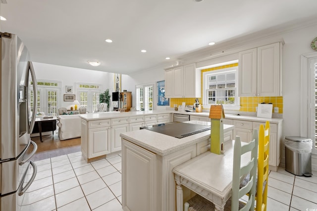 214 Sea Island Dr, Georgetown, SC 29440 - kitchen featuring stainless steel appliances, a peninsula, light tile patterned flooring, light countertops, and open floor plan