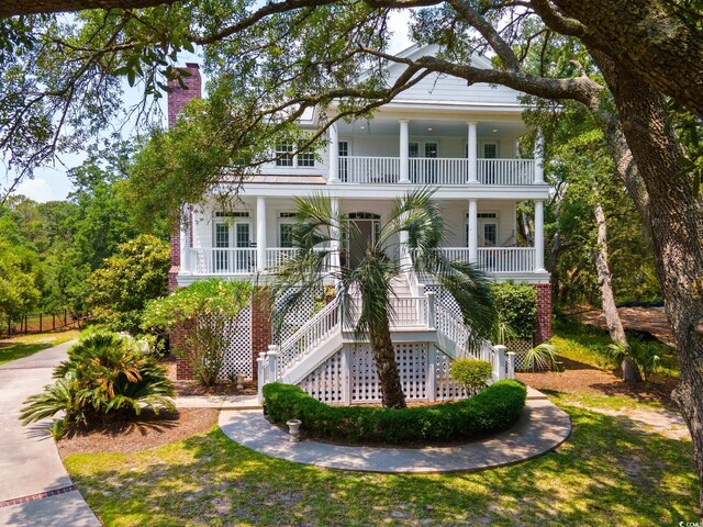 214 Sea Island Dr, Georgetown, SC 29440 - view of front of home with a porch, stairway, and a chimney