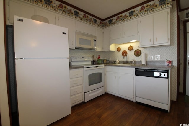 1582 S Waccamaw Dr Unit 56, Garden City Beach, SC 29576 - kitchen featuring white appliances, dark wood-style floors, tasteful backsplash, dark countertops, and ornamental molding