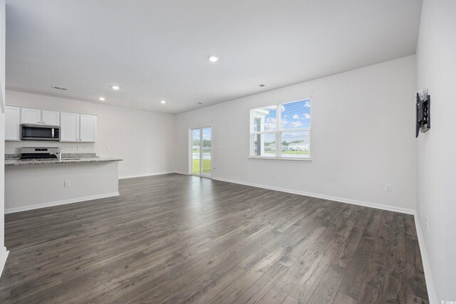 3573 Bells Lake Cir, Longs, SC 29568 - unfurnished living room featuring dark wood finished floors, recessed lighting, and baseboards