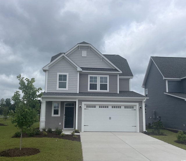 1260 Saxon Ct, Myrtle Beach, SC 29579 - view of front of home with concrete driveway, a front lawn, a garage, and a shingled roof