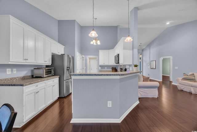137 Maiden Ln, Myrtle Beach, SC 29588 - kitchen featuring high vaulted ceiling, stainless steel appliances, white cabinetry, dark wood-style floors, and a peninsula