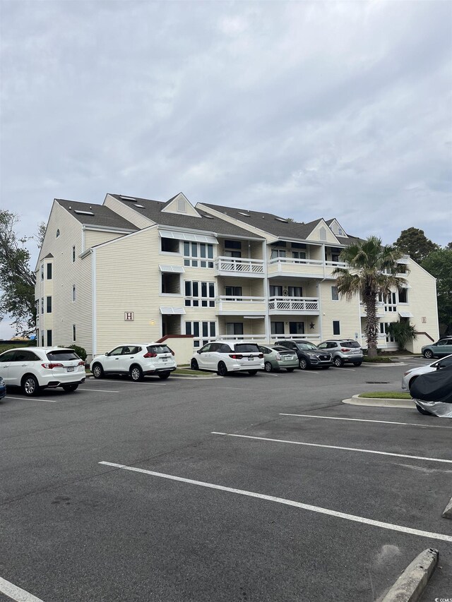 1100 Possum Trot Rd Unit H-233, North Myrtle Beach, SC 29582 - view of building exterior with uncovered parking