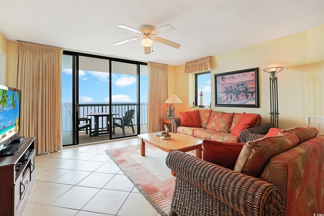 201 S Ocean Blvd Unit 1106, North Myrtle Beach, SC 29582 - living area with ceiling fan, light tile patterned floors, expansive windows, plenty of natural light, and a textured ceiling