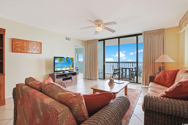 201 S Ocean Blvd Unit 1106, North Myrtle Beach, SC 29582 - living area with a ceiling fan, light tile patterned flooring, floor to ceiling windows, and a textured ceiling