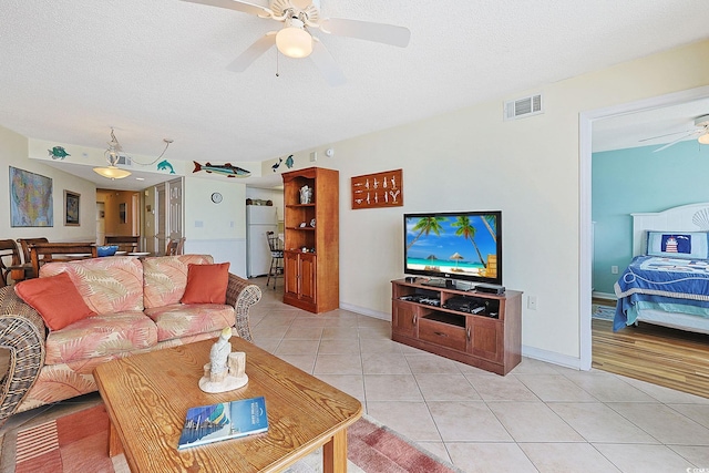 201 S Ocean Blvd Unit 1106, North Myrtle Beach, SC 29582 - living area featuring ceiling fan, light tile patterned floors, and a textured ceiling