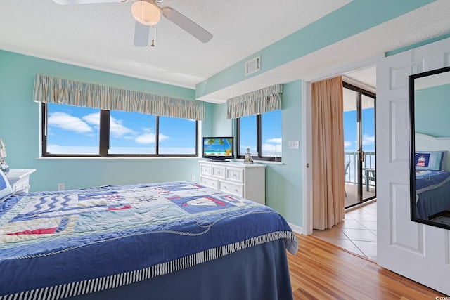 201 S Ocean Blvd Unit 1106, North Myrtle Beach, SC 29582 - bedroom with light wood-style floors, ceiling fan, and a textured ceiling