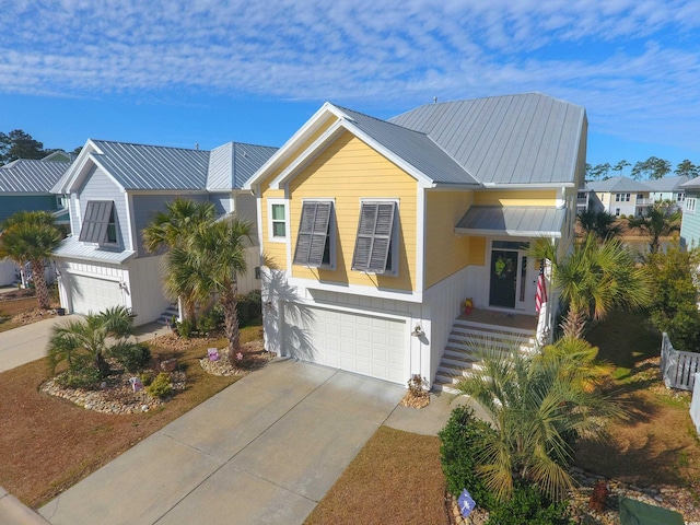 148 Splendor Cir, Murrells Inlet, SC 29576 - view of front of home featuring a garage, concrete driveway, and metal roof