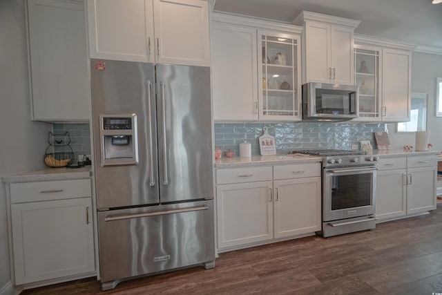 148 Splendor Cir, Murrells Inlet, SC 29576 - kitchen featuring stainless steel appliances, white cabinetry, decorative backsplash, and ornamental molding