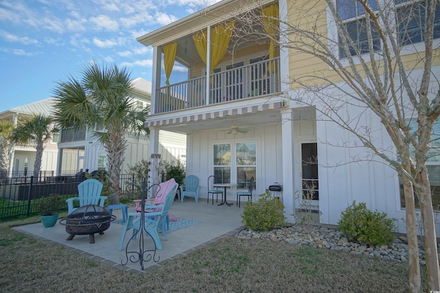 148 Splendor Cir, Murrells Inlet, SC 29576 - rear view of house featuring a balcony, an outdoor fire pit, board and batten siding, a ceiling fan, and a patio area