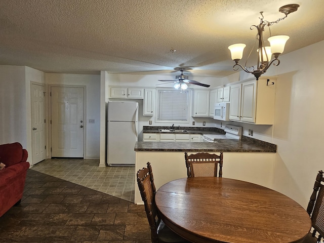 197 Charter Dr Unit D1, Longs, SC 29568 - kitchen with white appliances, dark countertops, ceiling fan, a sink, and a peninsula