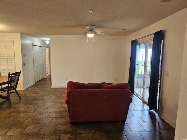 197 Charter Dr Unit D1, Longs, SC 29568 - living room featuring a ceiling fan, a textured ceiling, and baseboards