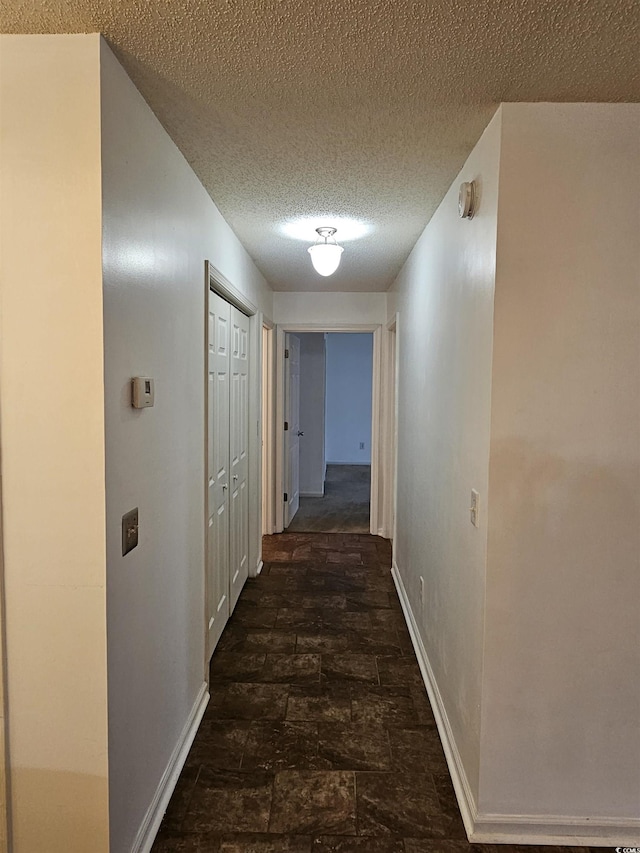 197 Charter Dr Unit D1, Longs, SC 29568 - hall featuring baseboards, a textured ceiling, and stone finish floors