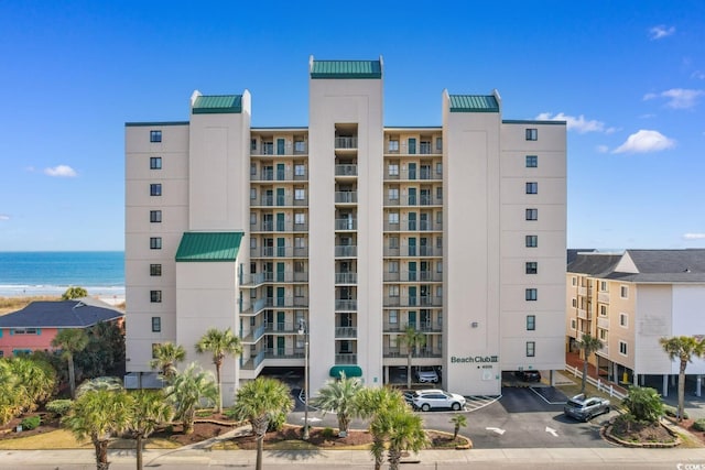 4505 S Ocean Blvd Unit 5D, North Myrtle Beach, SC 29582 - view of apartment building / complex featuring uncovered parking and a water view