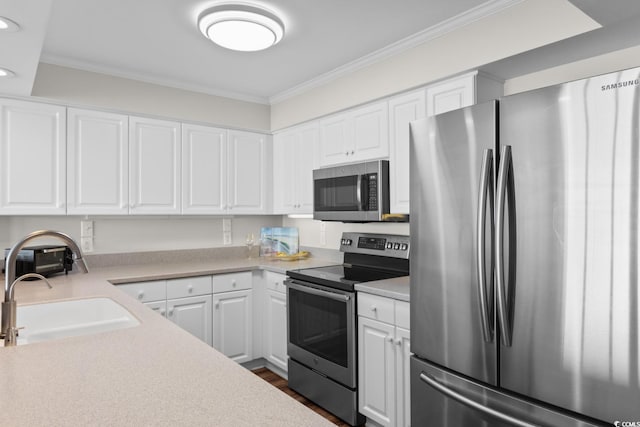 4505 S Ocean Blvd Unit 5D, North Myrtle Beach, SC 29582 - kitchen featuring stainless steel appliances, light countertops, ornamental molding, white cabinets, and recessed lighting