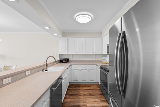4505 S Ocean Blvd Unit 5D, North Myrtle Beach, SC 29582 - kitchen with appliances with stainless steel finishes, a sink, crown molding, light countertops, and white cabinetry
