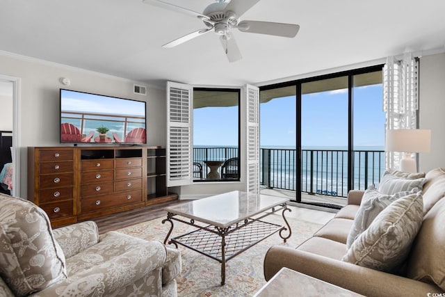 4505 S Ocean Blvd Unit 5D, North Myrtle Beach, SC 29582 - living room with wood finished floors, crown molding, ceiling fan, and floor to ceiling windows