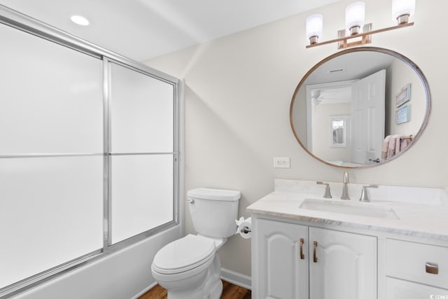4505 S Ocean Blvd Unit 5D, North Myrtle Beach, SC 29582 - bathroom featuring vanity, toilet, enclosed tub / shower combo, wood finished floors, and ceiling fan