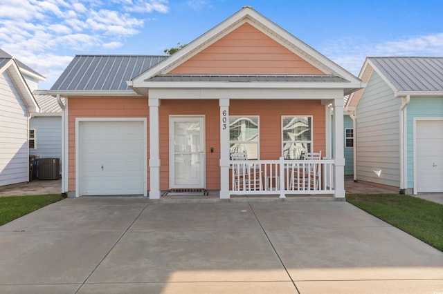 603 Wave Rider Ln Unit 603, North Myrtle Beach, SC 29582 - view of front facade featuring covered porch, metal roof, and cooling unit