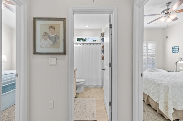 603 Wave Rider Ln Unit 603, North Myrtle Beach, SC 29582 - bedroom featuring light tile patterned floors, ensuite bathroom, baseboards, and a ceiling fan