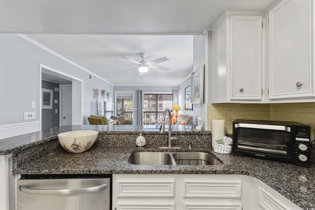 202 N Ocean Blvd Unit 109, North Myrtle Beach, SC 29582 - kitchen featuring stainless steel dishwasher, a sink, ceiling fan, white cabinets, and dark stone counters