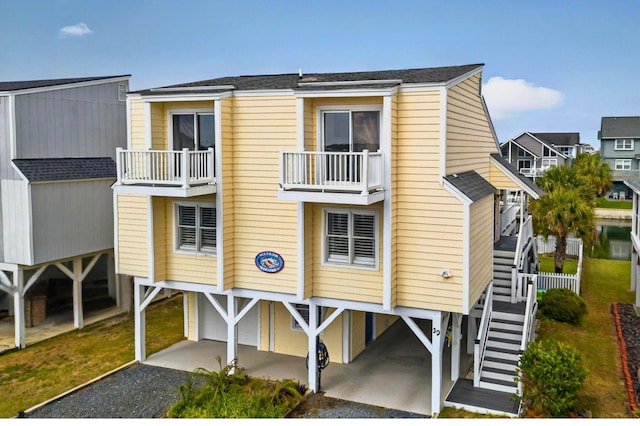 39 Newport St, Ocean Isle Beach, NC 28469 - view of building exterior with a carport, gravel driveway, and stairway